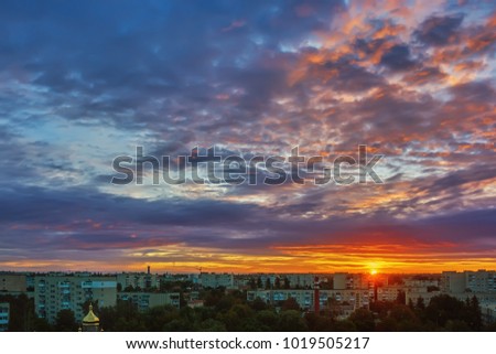 Sky with clouds over the city at sunset.