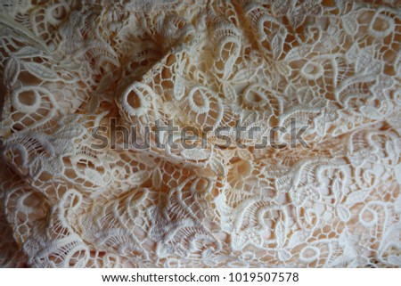 Folded beige old fashioned net like lace
