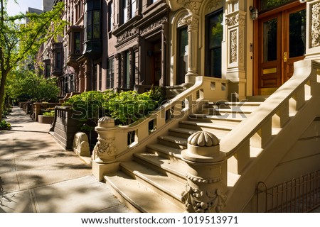 Brownstones with doorsteps and ornament in morning light. Upper West Side Street, Manhattan, New York City Royalty-Free Stock Photo #1019513971