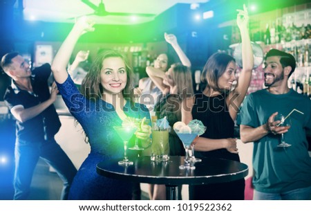 Young woman is enjoying amazing party in nightclub
