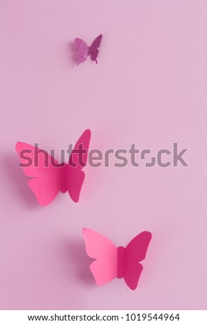 Paper butterflies on a pink background. Love and Valentine's day concept. Top view