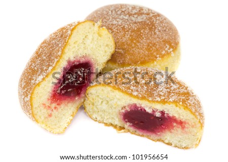 A picture of two jelly donuts where one is cutted in half, showing jelly