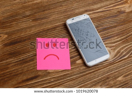 phone with a broken screen 
