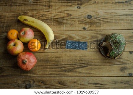 a fruit and donut with chocolate on a wooden background