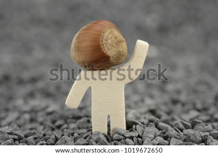 Wooden male with hazelnut instead of head