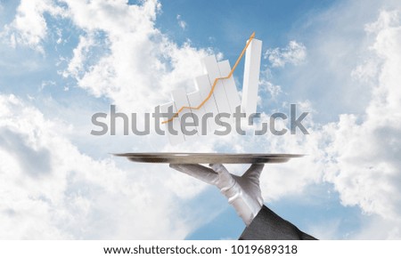 Cropped image of waitress's hand in white glove presenting growing arrow graph on metal tray with cloudy skyscape on background.