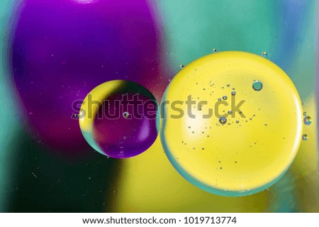 Colored drops of oil on water