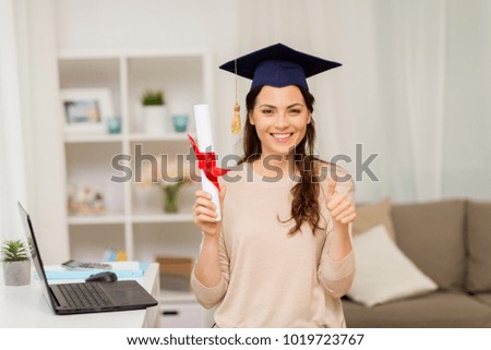 education, graduation and people concept - happy female student with diploma at home showing thumbs up