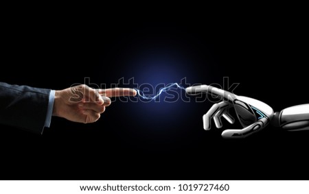 business, future technology and artificial intelligence concept - robot and human hand connected by lightning over black background