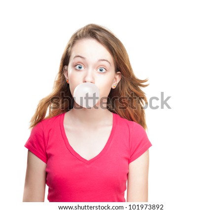 Beautiful and shocked or surprised young student girl blowing bubble from chewing gum. Looking into the camera. Isolated on white background.