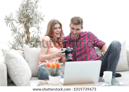 young couple makes viewing photos in photo camera
