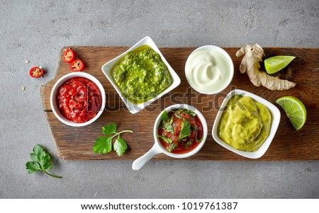various dip sauces on grey table, top view Royalty-Free Stock Photo #1019761387