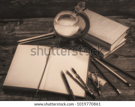 ancient the glass barometer with stationery accessories. on wooden table. 