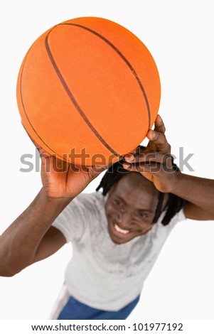 High angle view of smiling basketball player against a white background