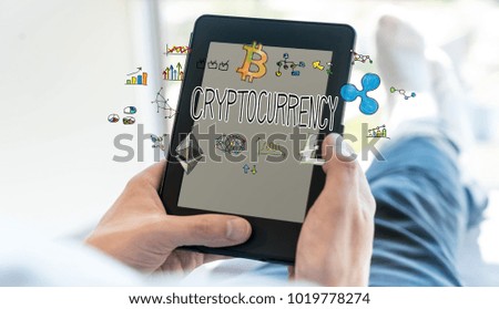Cryptocurrency with man using a tablet computer