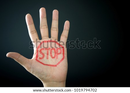 Hand with stop sign isolated on black background
