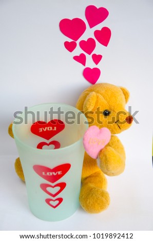 Single cute teddy bears fall in love with shape heart.He wait to fill up with love concept on valentine day with isolated white background.