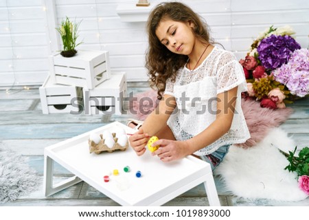 girl decorating eggs