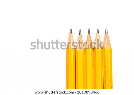 Multiple sharpened pencils against a white background
