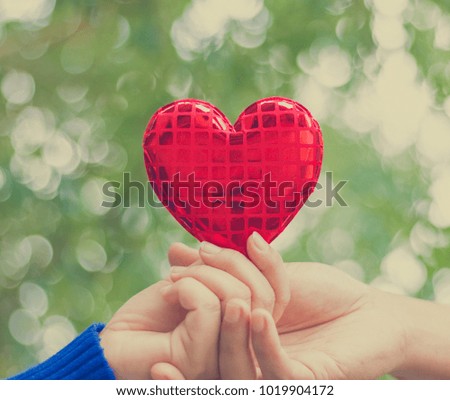 Human hand showing holding heart sign with background, Valentine's day concept.