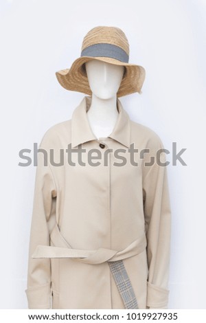 female in coat with hat on mannequin
