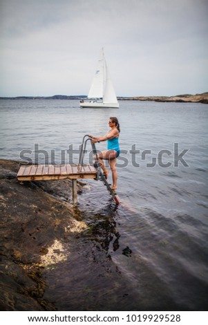 A woman going into the sea water, Marstrand, Bohuslän, Sweden