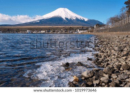 Frozen Water in Lake Yamanaka and Mount Fuji Covered with Snow Cap under Clear Blue Sky