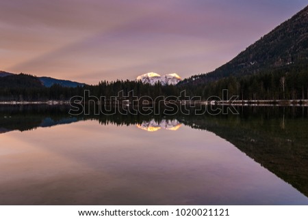 Sunset at lake Hintersee in the Alps of Bavaria on a cloudy evening in winter