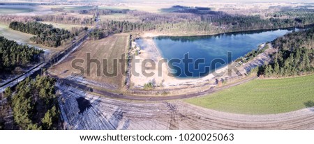 Aerial landscape photo, aerial photo with a lake, fields, meadows, forests and a road, panorama as a banner for a blog or a website, drone landscape photo.