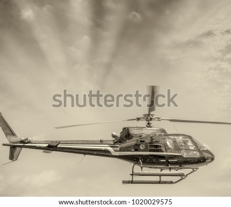 Helicopter taking off in the sky at dusk.