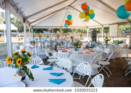 Tables set up for a dinner event.  Royalty-Free Stock Photo #1020035221