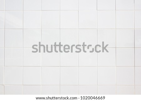 white tiles wall in the office White tiled wall for bedroom, kitchen, bathroom and interior design. White tiled wall in clean and symmetrical textured background view with grid texture background.