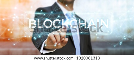 Businessman on blurred background using blockchain cryptocurrency interface 3D rendering