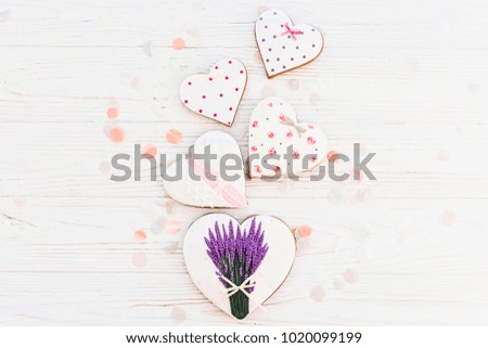 happy mother's day greeting card. cookie hearts with lavender flowers on white rustic wooden background with confetti flat lay. space for text. happy valentine's day or women's