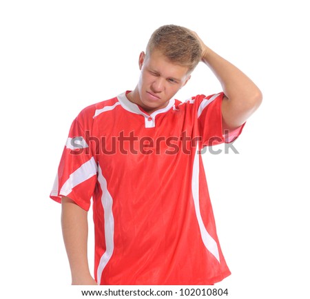 Image of a young football player with the ball in the red uniform. Isolated on white background