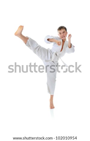 Young boy training karate. Isolated on white background