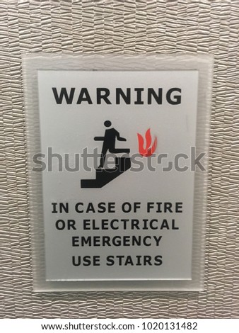 Warning in case of fire or electrical emergency use stairs -Interior warning sign by elevator