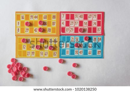 Bingo Board game. Bingo, playing cards and game chips on white background