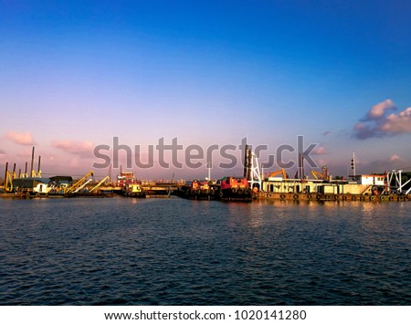 Deep Sea Port scenery before twilight sunset. Beautiful view at industry places in a small city of Thailand.Picture for presented maritime economy resources.