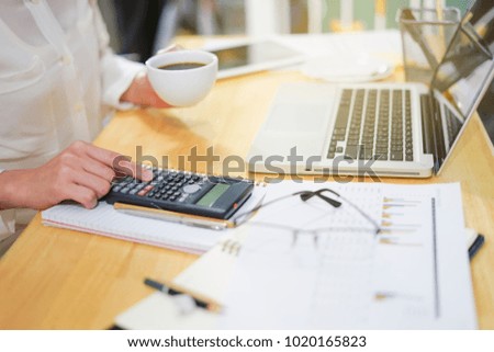 Asian business woman working on laptop in her workplace.