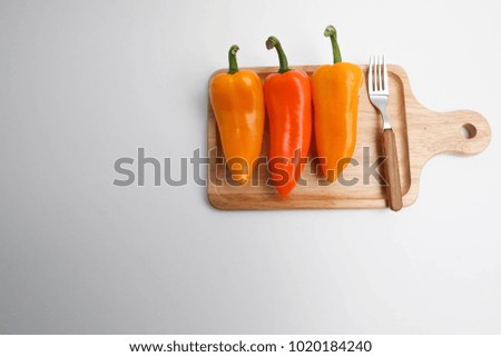 3 paprika and forks on the board