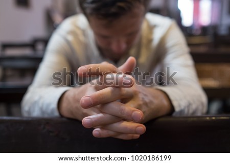 caucasian man praying in church. He has problems and ask God for help. Concept of religion faith Royalty-Free Stock Photo #1020186199