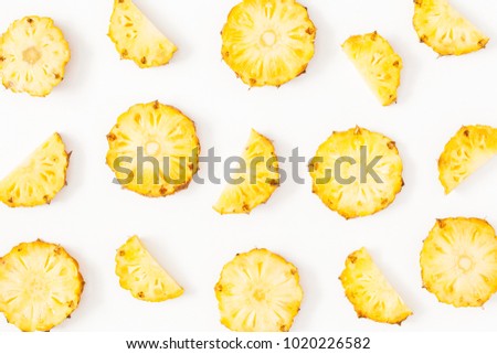 Pineapples on white background. Pattern made of sliced pineapples. Flat lay, top view, copy space