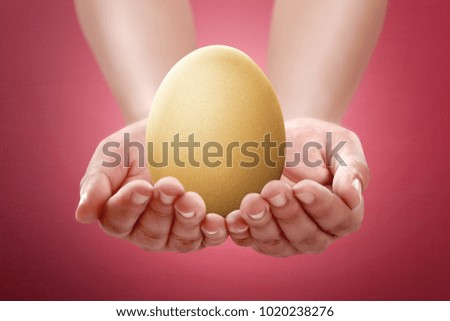 Image of people hand hold plain egg. Easter concept, you can design your own pattern at the egg