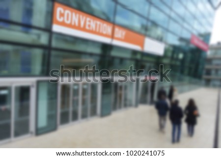 Business convention perspective view external entrance to location with Convention Day sign            