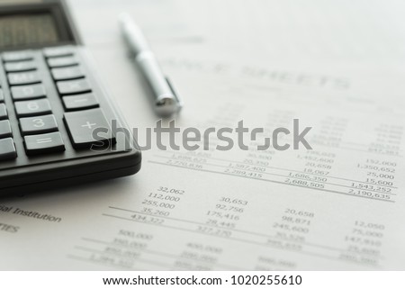 Accounting business concept. Calculator with accounting report and financial statement on desk. Royalty-Free Stock Photo #1020255610