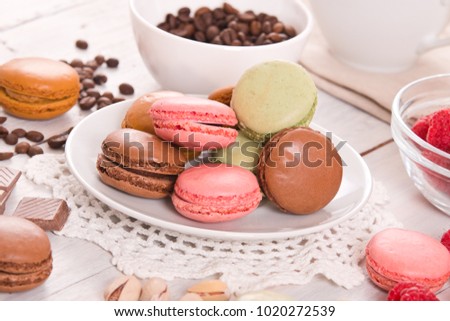 Colorful macarons on wooden table. 