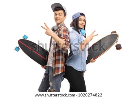Teenage hipsters with longboards making peace signs isolated on white background