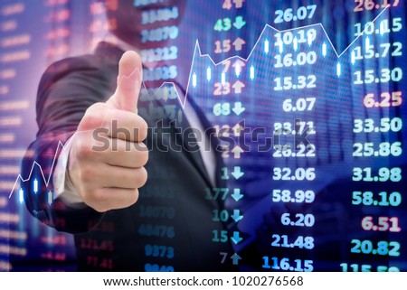 Double exposure businessman showing hand sign thumb and stock market chart financial data on electronic board background, The excellence of stock market