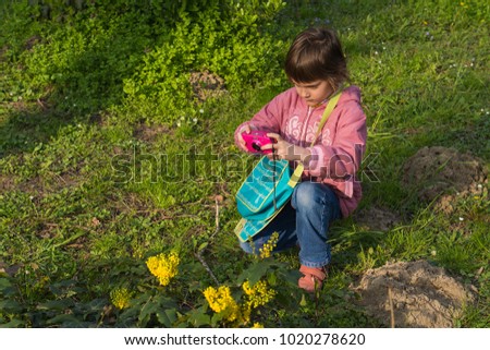 A little girl photographer in nature